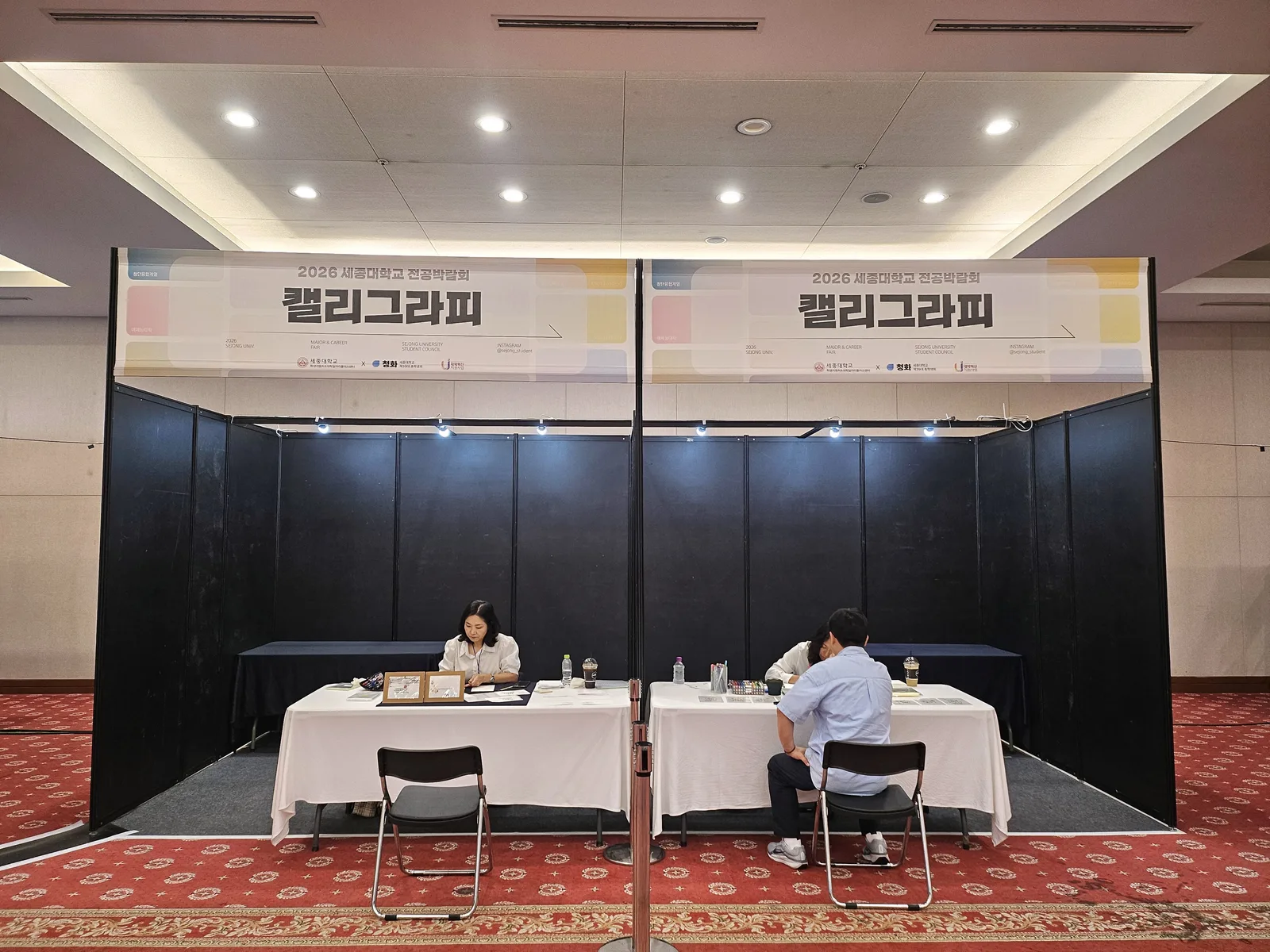 전공박람회 캘리그라피 체험부스 2칸 운영 전경 — 현수막과 상담 테이블